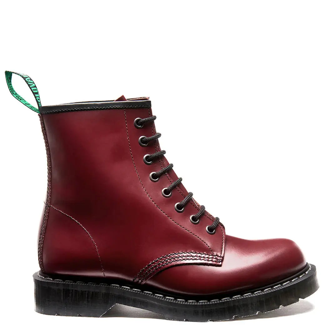 Red leather boot with black sole on a white background