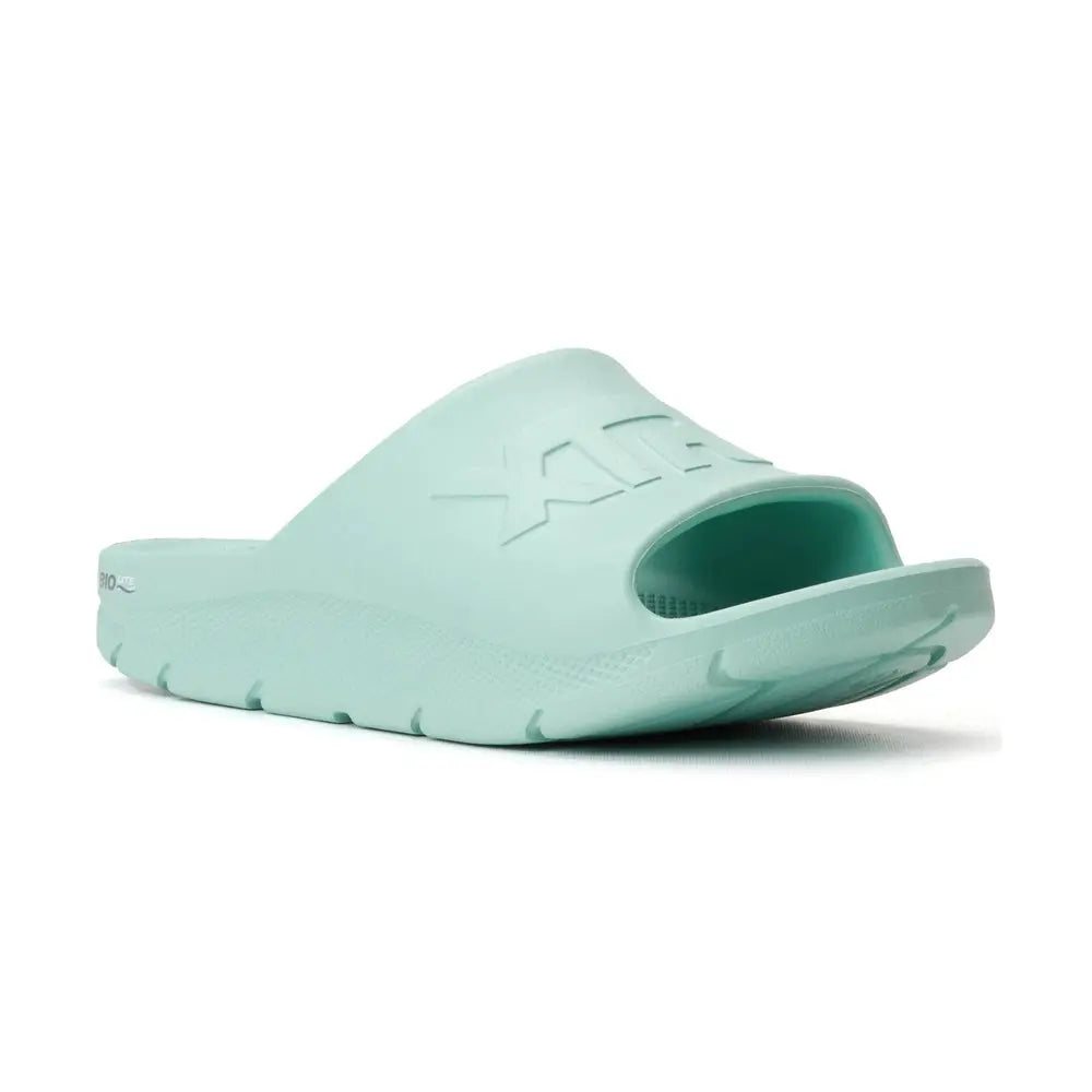 Light green Apres Fish slide sandal with "XTRATUF" embossed on the strap, featuring a textured sole.