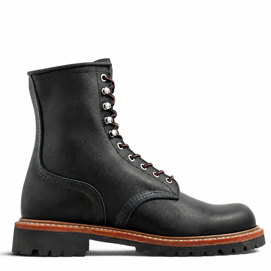 A black leather lace-up work boot with silver metal eyelets, a brown welt, and a black lug sole, shown in a side profile on a white background.