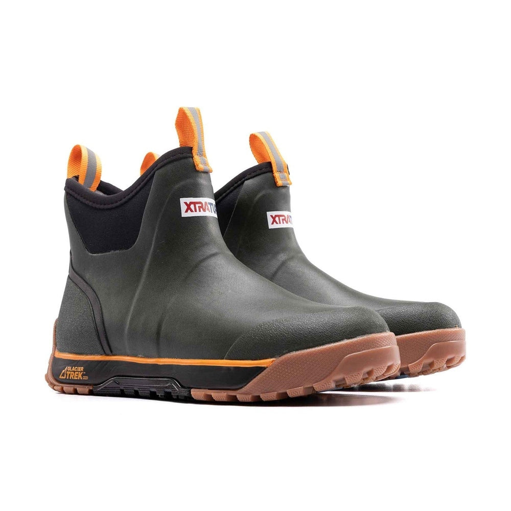 Pair of dark green ADB Ice Boots with orange trim, pull tabs, and brown Glacier Trek Pro soles.
