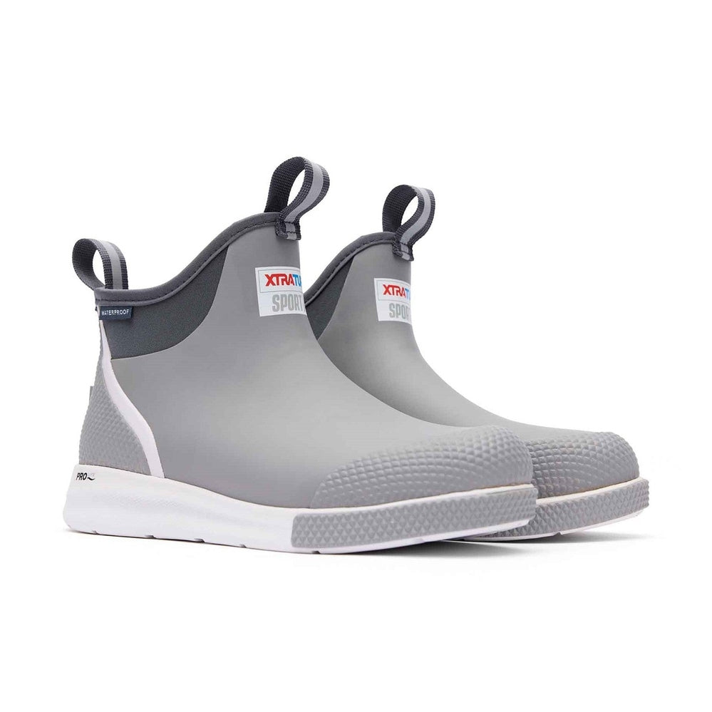 Pair of grey Xtratuf Ankle Deck Boot Sport with white soles and pull tabs.