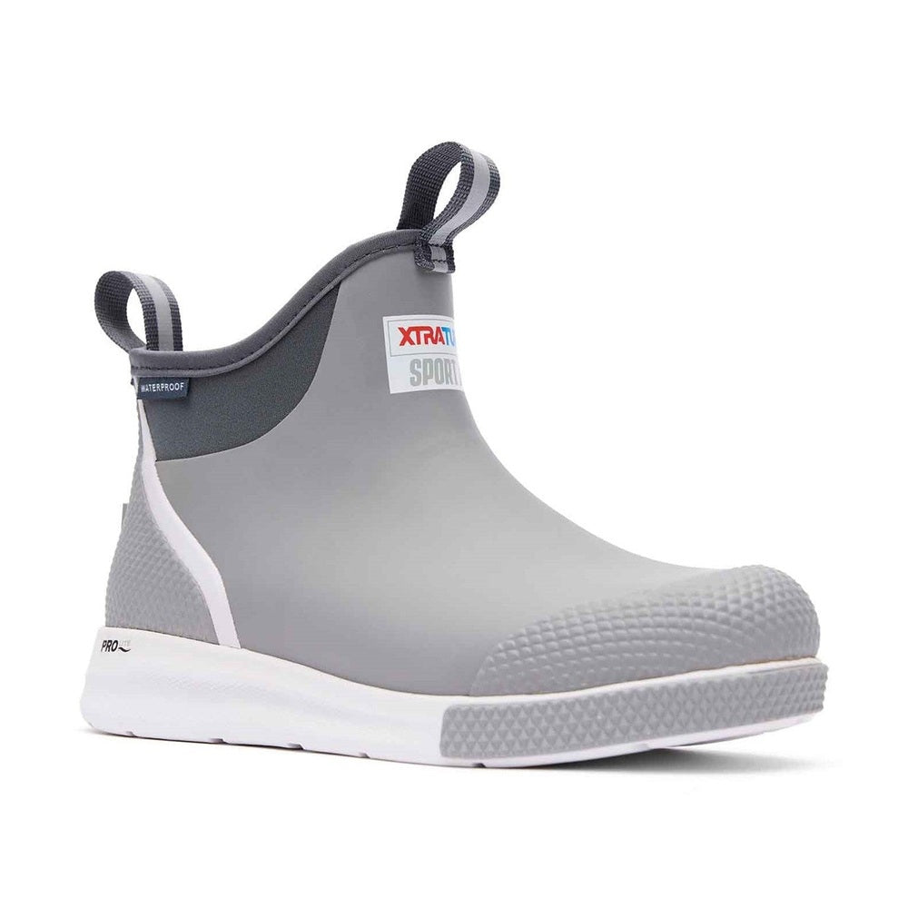 Grey Xtratuf Ankle Deck Boot Sport with white sole, pull tabs, and "WATERPROOF" label.