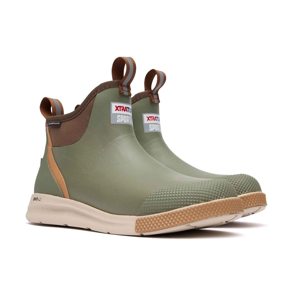 Green XTRATUF Ankle Deck Boot Sport with brown trim, tan sole, and reflective pull tabs.