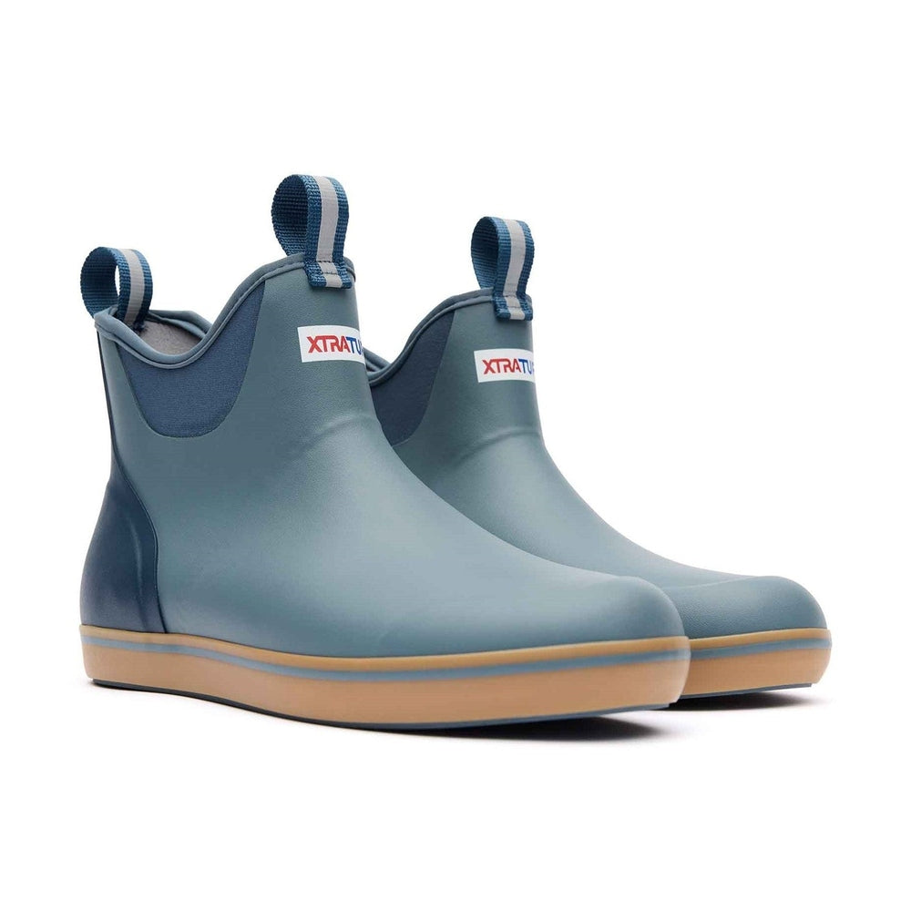 Pair of slate blue XTRATUF Ankle Deck Boots with tan soles and blue pull tabs.