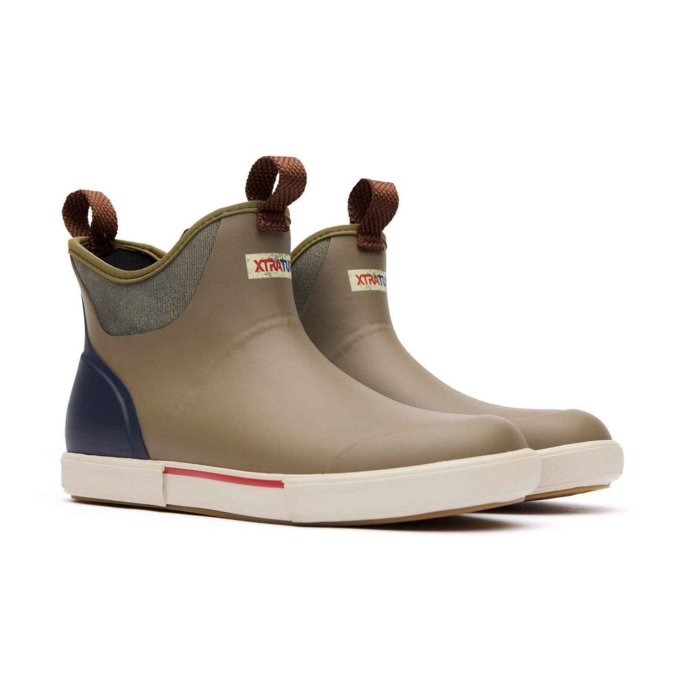 XTRATUF Ankle Deck Vintage Boot in tan with navy heel, brown pull tabs, and white slip-resistant sole.