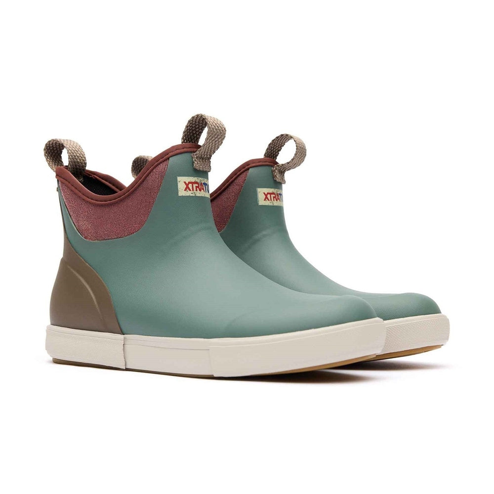 XTRATUF Ankle Deck Vintage Boots in teal and brown with white soles and pull tabs.