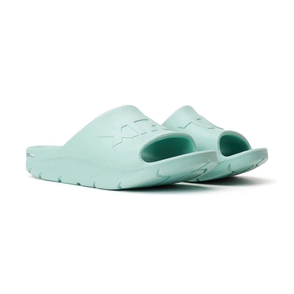 Light green Apres Fish slide sandals, one-piece eco-conscious design with textured sole and embossed logo.