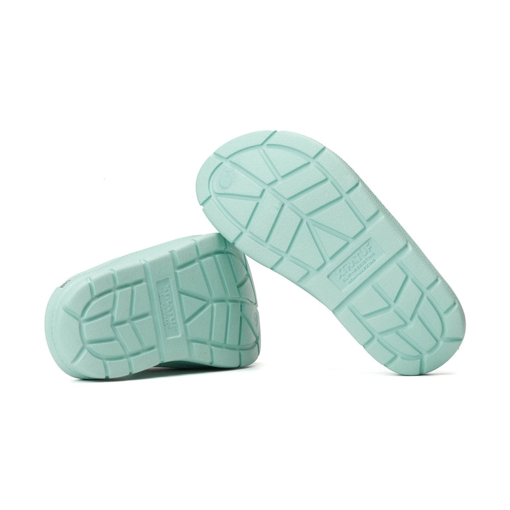 Pair of light teal Apres Fish slides, showing their textured, slip-resistant outsoles.