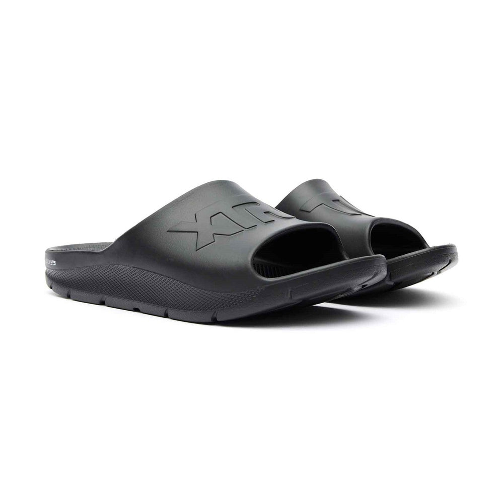 Pair of black Apres Fish slides with textured soles and "XTRATUF" embossed on the strap.