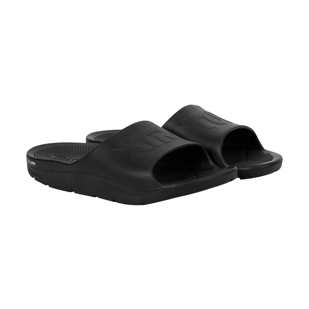 Pair of black Apres Fish slides with textured footbeds and embossed logos.