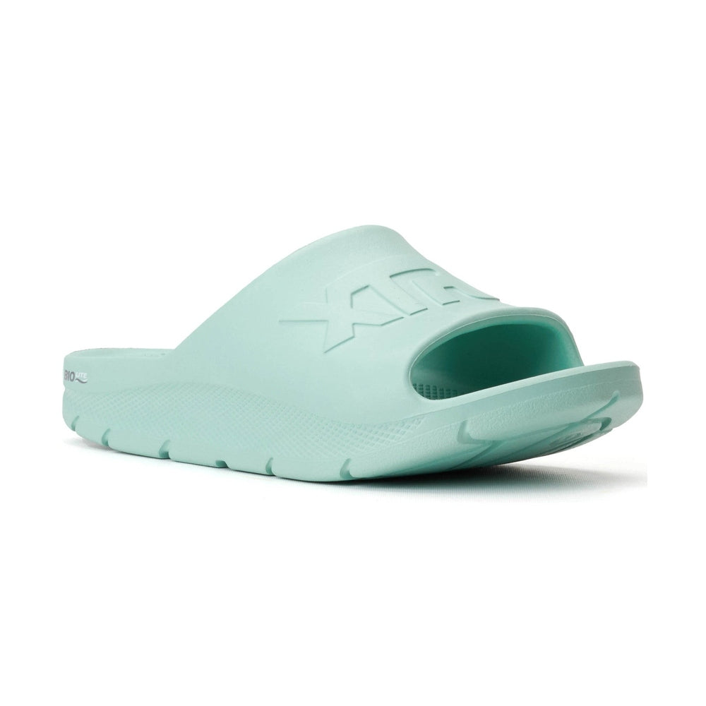 Light green Apres Fish slide sandal with "XTRATUF" embossed on the strap, featuring a textured sole.
