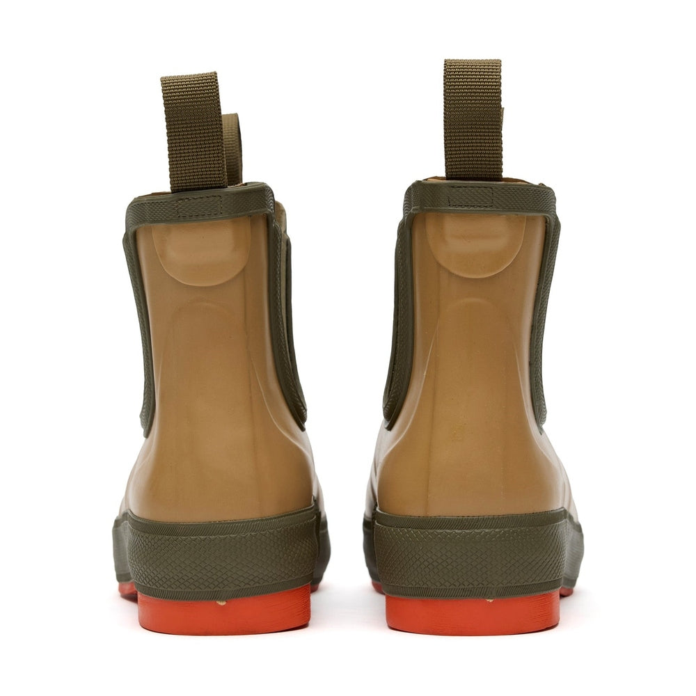 Pair of tan Legacy Deck Boots with olive green trim, pull tabs, and bright orange soles.