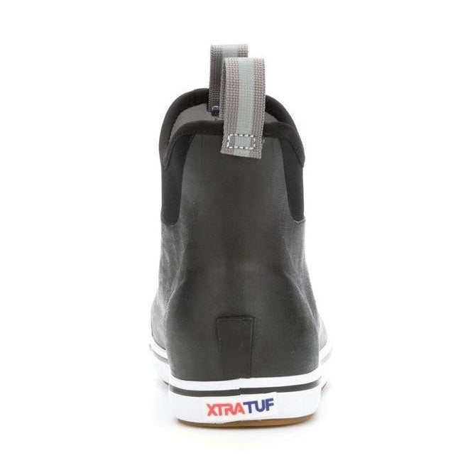 Women's Xtratuf Ankle Deck Boot in black, featuring a slip-on design, pull tab, and white sole with red logo.