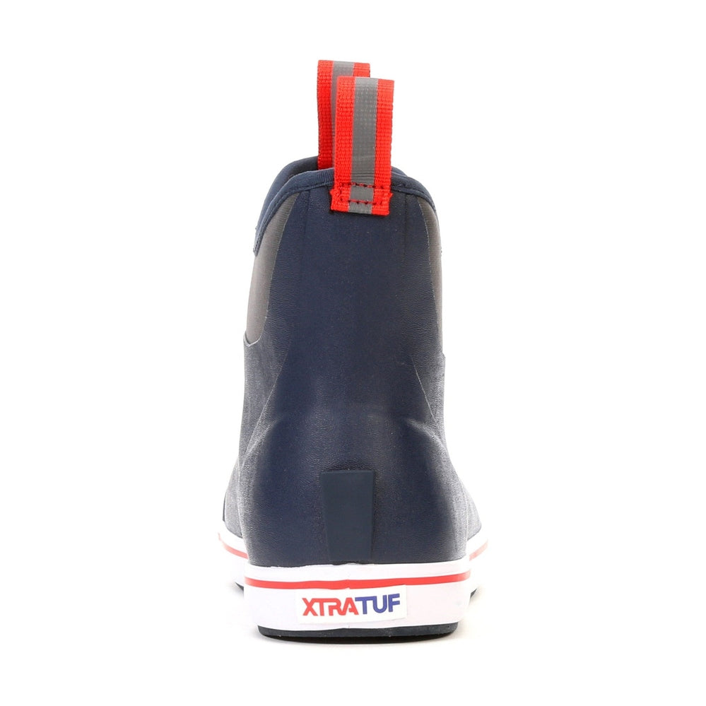 Navy Xtratuf Ankle Deck Boot with red pull tabs and white sole, showing the back view.