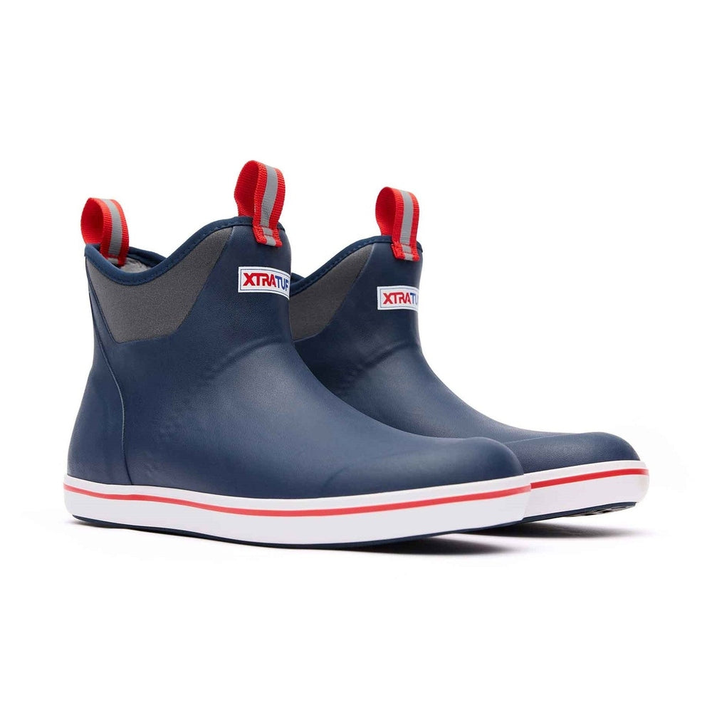 Navy and red Xtratuf Ankle Deck Boots with gray trim, white soles, and red pull tabs.